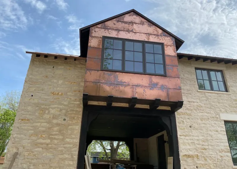Copper metal panel facade on a stone building for Skylight Installation in Palmdale